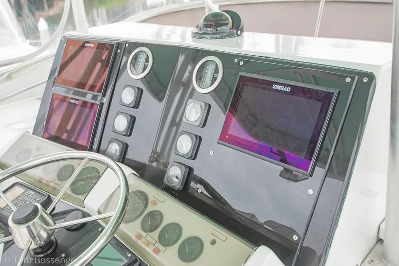 Slide: The Image of Dashboard of a 1988 Chris-Craft 482 Convertible boat with Simrad navigation displays. - 31