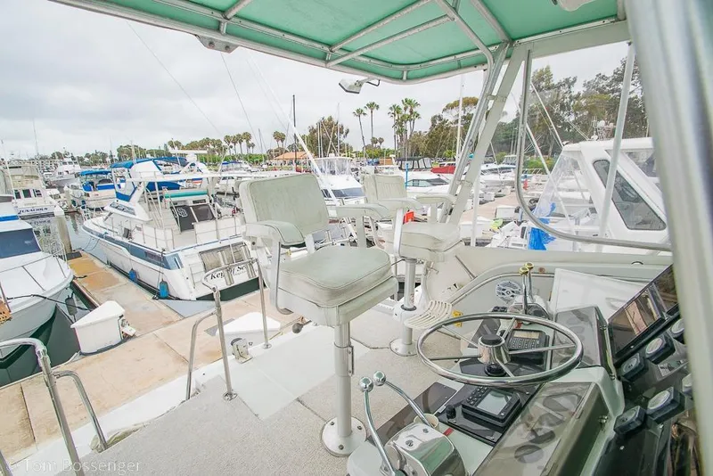 Slide: The Image of 1988 Chris-Craft 482 Convertible yacht helm with marina view. - 34