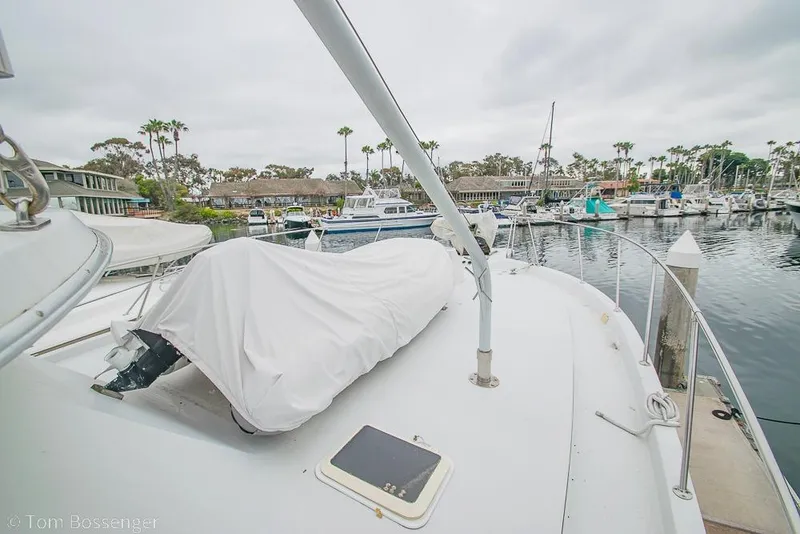 Slide: The Image of 1988 Chris-Craft 482 Convertible yacht docked at a marina, covered and ready for use. - 36