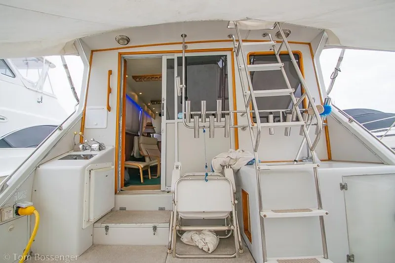 Slide: The Image of 1988 Chris-Craft 482 Convertible yacht interior with ladder and seating area. - 4