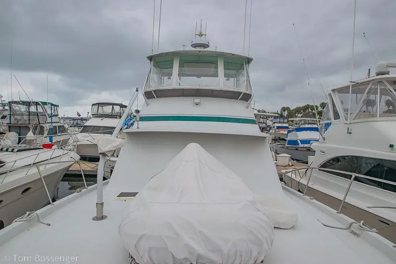 Slide: The Image of 1988 Chris-Craft 482 Convertible yacht docked at marina under cloudy skies. - 41