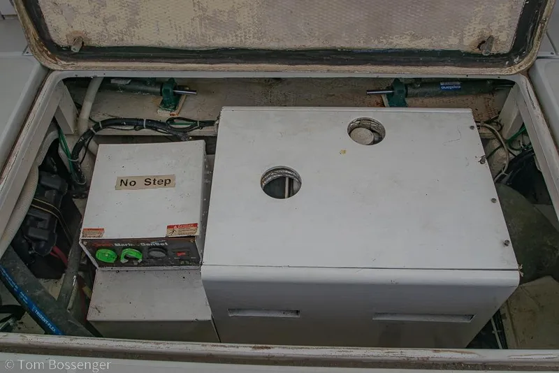 Slide: The Image of Engine compartment of 1988 Chris-Craft 482 Convertible boat, featuring machinery and "No Step" warning. - 42
