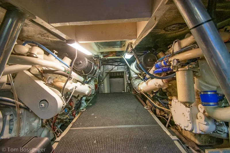 Slide: The Image of Engine room of 1988 Chris-Craft 482 Convertible yacht, showcasing mechanical components and systems. - 43