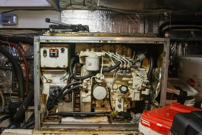Slide: The Image of Engine room of a 1988 Chris-Craft 482 Convertible boat, showcasing machinery and components. - 46
