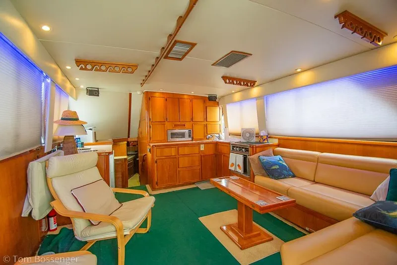 Slide: The Image of Luxurious interior of 1988 Chris-Craft 482 Convertible yacht with cozy seating and wooden cabinetry. - 5