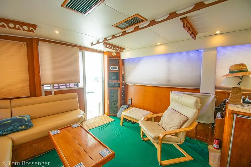 Slide: The Image of Interior of 1988 Chris-Craft 482 Convertible yacht with cozy seating and wooden accents. - 7