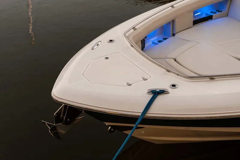 Slide: The Image of The 2027 Boston Whaler 380 Realm is docked, featuring blue lighting in the bow area. - 43