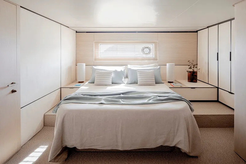 Slide: The Image of The image shows a luxurious cabin with a large bed, surrounded by elegant wooden walls. - 13