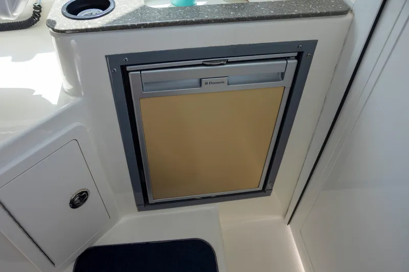 Slide: The Image of Compact Dometic refrigerator on 2014 Boston Whaler 315 Conquest boat interior. - 5