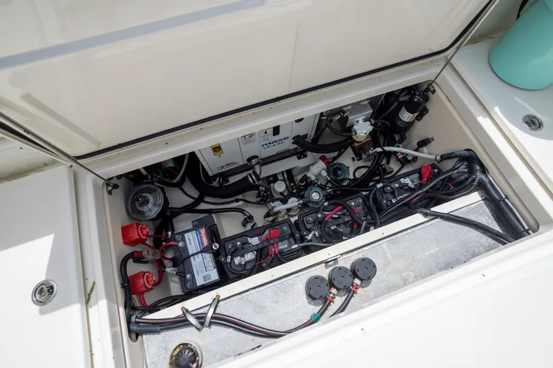 Slide: The Image of Engine compartment of a 2014 Boston Whaler 315 Conquest, showcasing wiring and battery setup. - 6