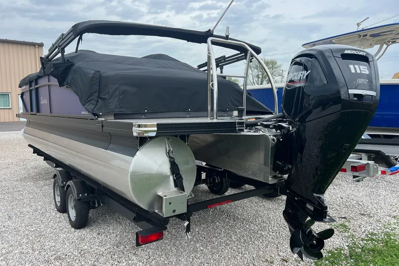 Slide: The Image of 2023 Barletta C22 pontoon boat with Mercury 115 GT engine, covered and on a trailer. - 10
