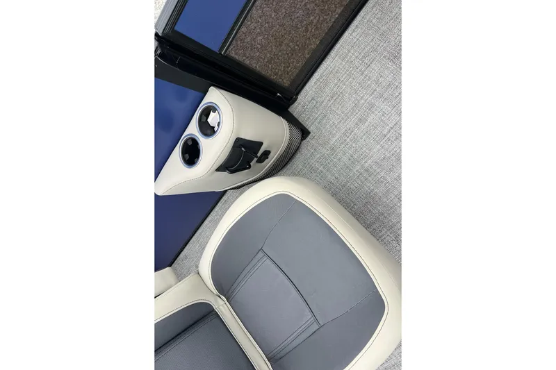 Slide: The Image of 2023 Barletta C22 boat interior with gray and beige seating, cup holders, and carpeted flooring. - 13