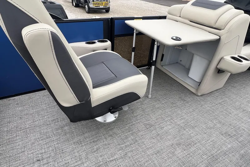 Slide: The Image of 2023 Barletta C22 boat interior with seating, table, and storage compartment. - 15
