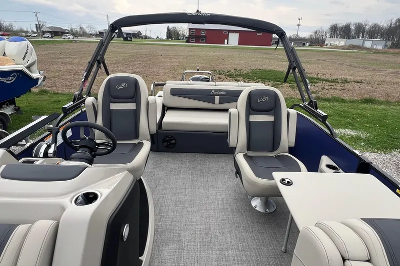 Slide: The Image of 2023 Barletta C22 pontoon boat interior with plush seating and modern helm. - 25