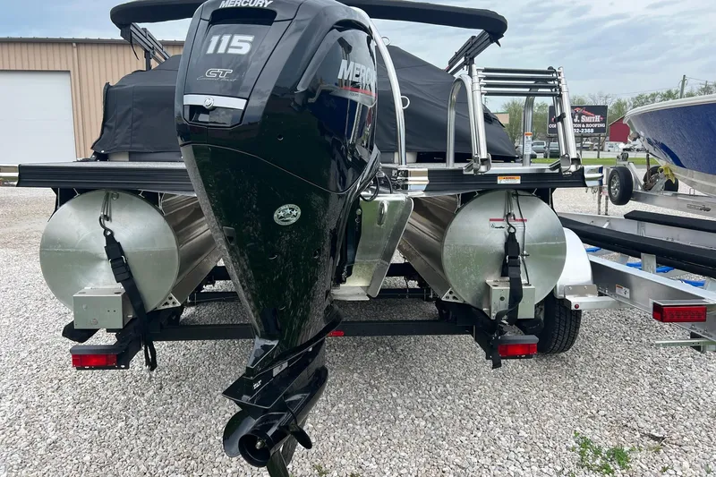 Slide: The Image of 2023 Barletta C22 pontoon boat with Mercury 115 GT engine, parked on gravel. - 9