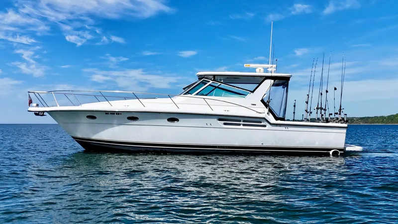 Slide: The Image of 1999 Tiara Yachts 4100 Open on calm water under blue sky. - 11