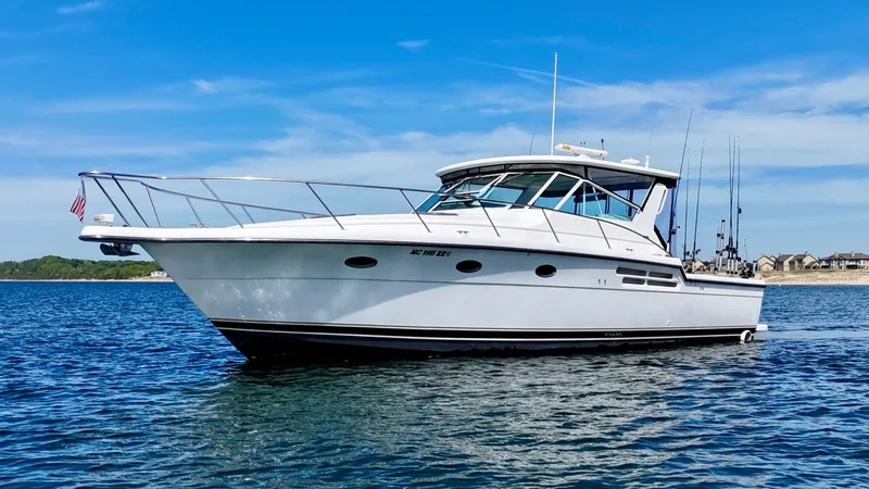 Slide: The Image of 1999 Tiara Yachts 4100 Open on calm water. - 12