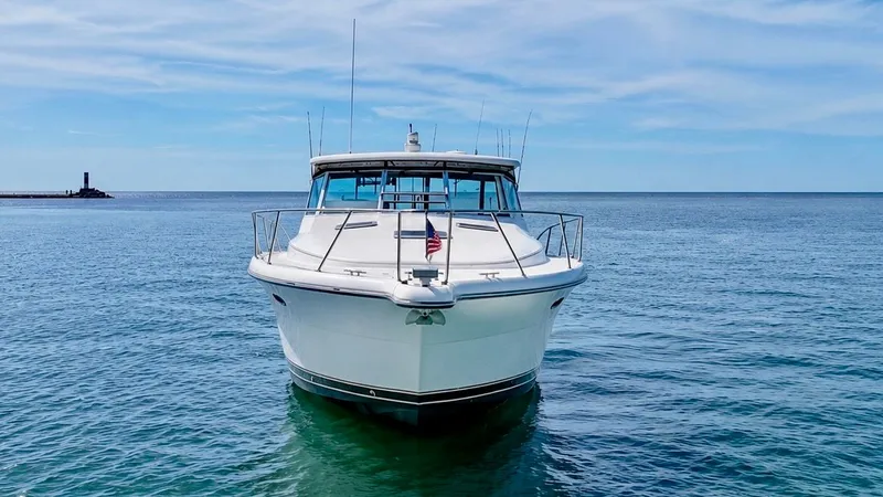 Slide: The Image of 1999 Tiara Yachts 4100 Open on calm sea under clear sky. - 13