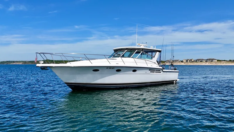Slide: The Image of 1999 Tiara Yachts 4100 Open on calm waters. - 15