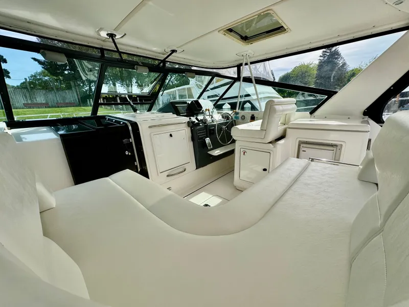Slide: The Image of Interior of a 1999 Tiara Yachts 4100 Open with white seating. - 2