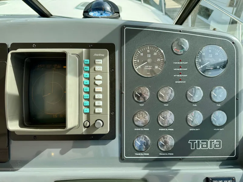 Slide: The Image of Dashboard of 1999 Tiara Yachts 4100 Open with instruments and radar. - 23