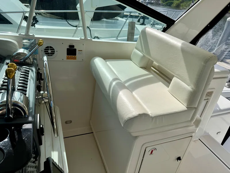 Slide: The Image of Interior of a 1999 Tiara Yachts 4100 Open, helm station with seating. - 26
