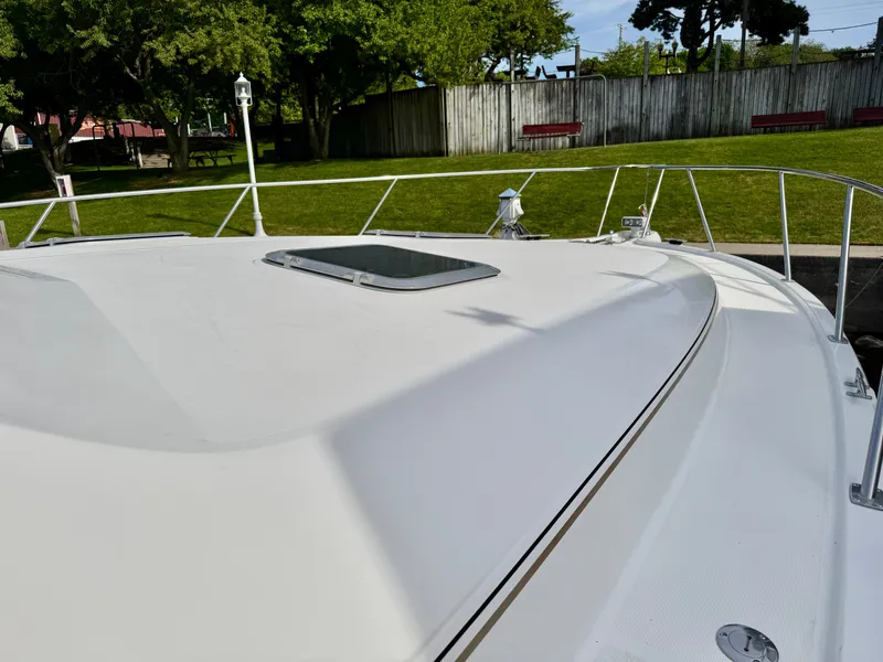 Slide: The Image of 1999 Tiara Yachts 4100 Open deck with green background. - 31