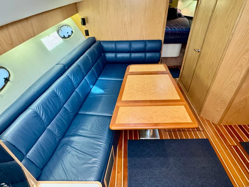Slide: The Image of 1999 Tiara Yachts 4100 Open interior with blue leather couch. - 36
