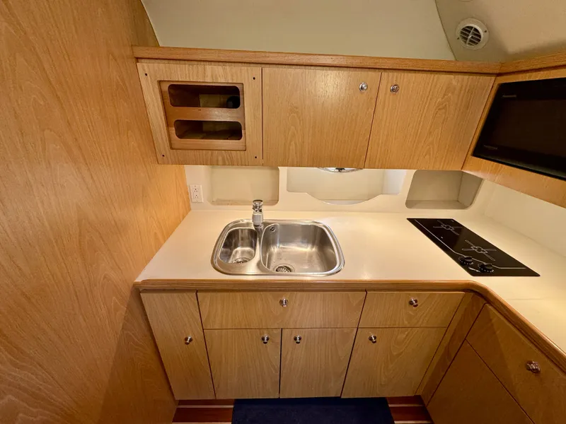 Slide: The Image of Tiara Yachts 4100 Open 1999 kitchen area with sink and stove. - 39