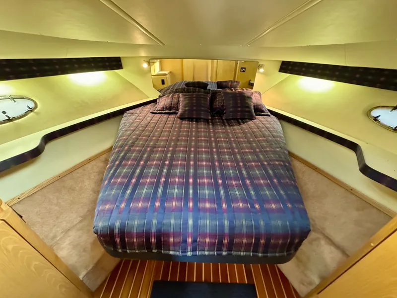 Slide: The Image of 1999 Tiara Yachts 4100 Open interior with cozy bed. - 5