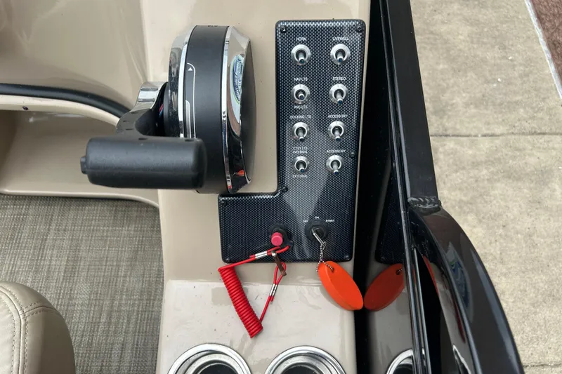 Slide: The Image of Control panel of a 2019 Bentley Pontoons 243 boat with switches and throttle. - 14
