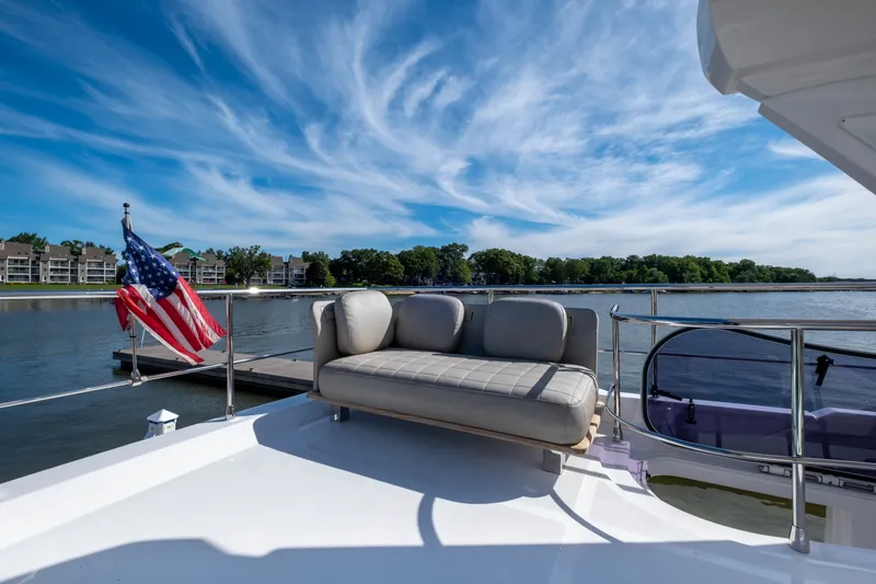 Slide: The Image of Azimut 50 Fly 2018 on calm water with flag and sofa. - 24