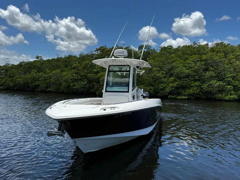 Slide: The Image of 2011 Boston Whaler 280 Outrage on calm water with green backdrop. - 3