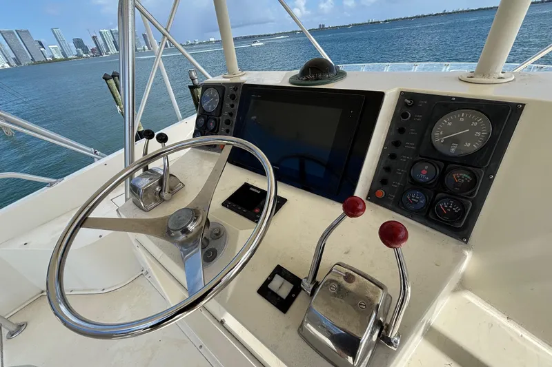 Slide: The Image of Helm of 1990 Viking 43 Convertible yacht with steering wheel and control panel. - 11