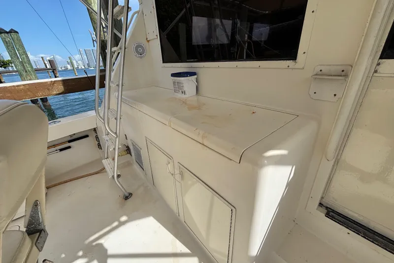 Slide: The Image of Interior view of a 1990 Viking 43 Convertible boat, featuring a storage area and ladder. - 14