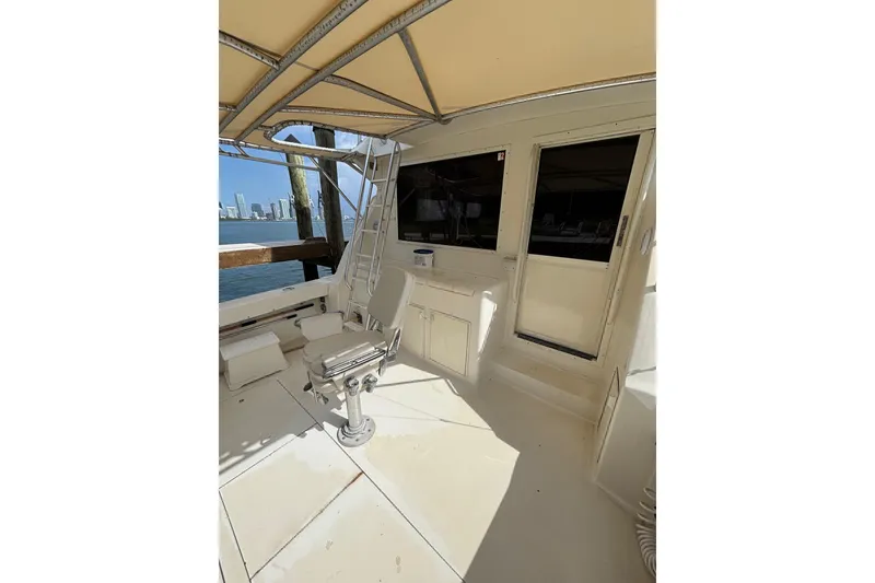 Slide: The Image of 1990 Viking 43 Convertible yacht deck with seating and ocean view. - 15