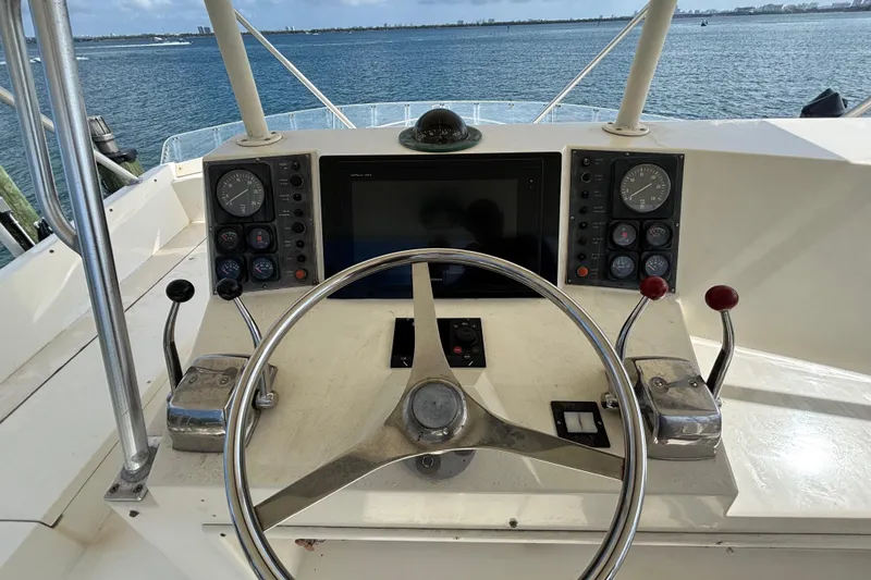 Slide: The Image of Helm of 1990 Viking 43 Convertible yacht with steering wheel and control panels. - 18