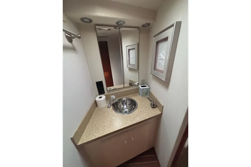 Slide: The Image of Compact bathroom in a 1990 Viking 43 Convertible yacht with sink and mirror. - 20