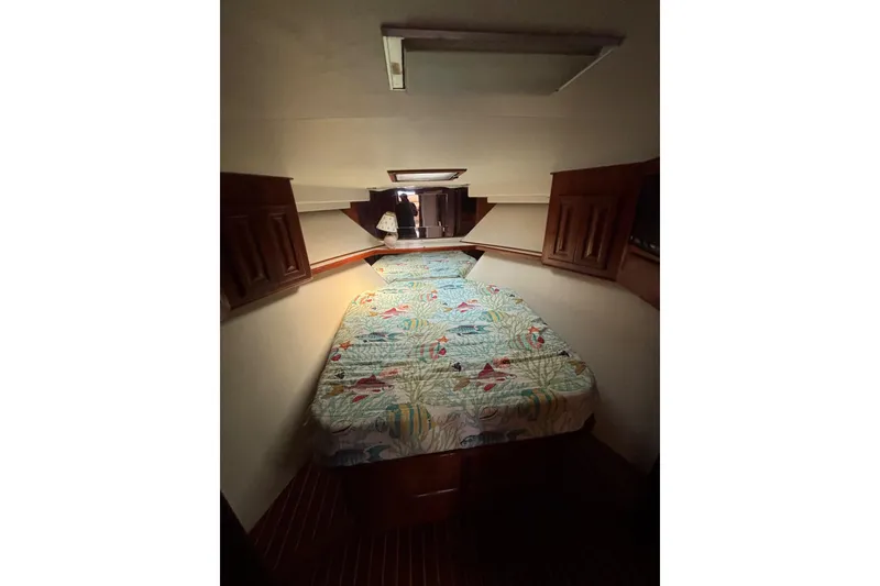 Slide: The Image of Cozy cabin interior of 1990 Viking 43 Convertible yacht with patterned bedding. - 22