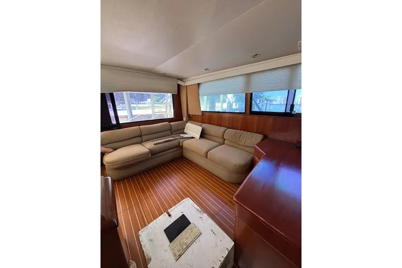Slide: The Image of Luxurious interior of a 1990 Viking 43 Convertible yacht with plush seating and wood flooring. - 24