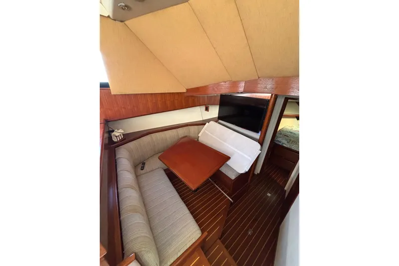 Slide: The Image of Interior of 1990 Viking 43 Convertible yacht with cozy seating and wooden table. - 25