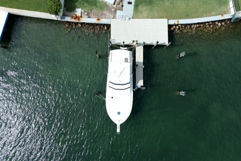 Slide: The Image of Aerial view of a 1990 Viking 43 Convertible yacht docked at a pier. - 4