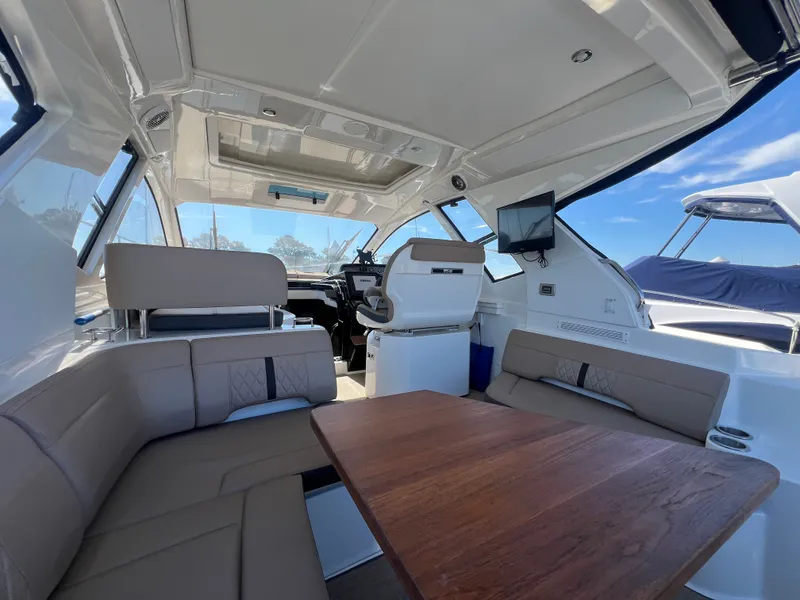 Slide: The Image of Interior of 2018 Sea Ray Sundancer 350 Coupe with seating and helm station. - 13