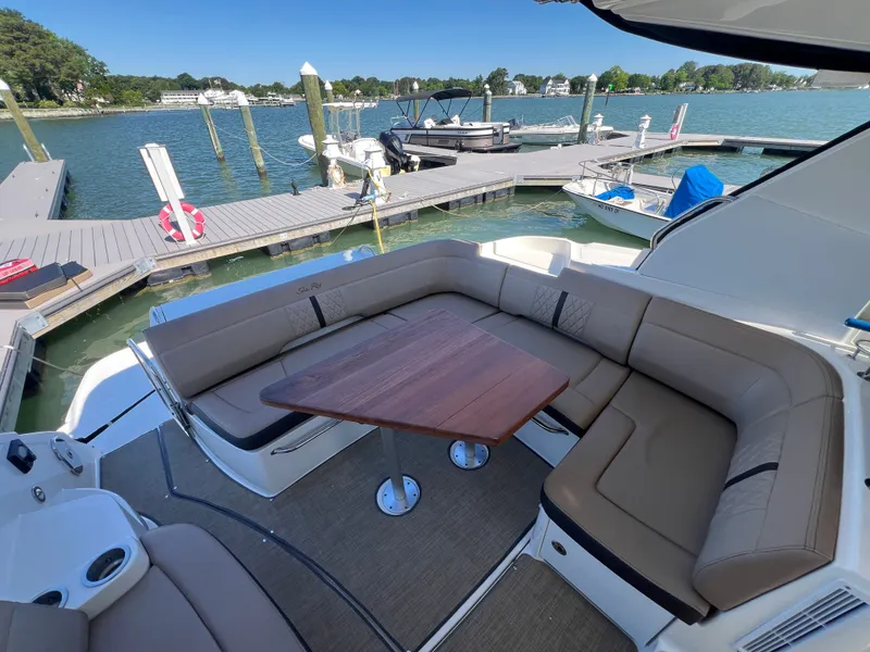 Slide: The Image of 2018 Sea Ray Sundancer 350 Coupe with elegant seating area at the dock. - 16
