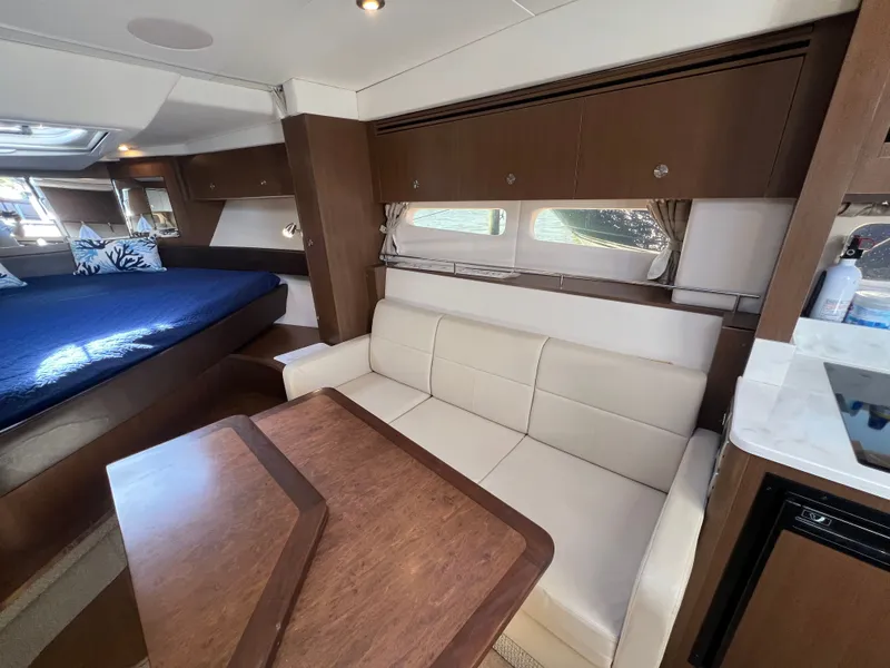 Slide: The Image of Interior of 2018 Sea Ray Sundancer 350 Coupe with sofa and table. - 28
