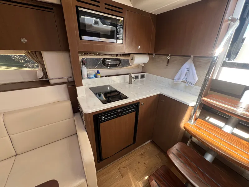 Slide: The Image of Interior of 2018 Sea Ray Sundancer 350 Coupe with modern kitchen. - 29