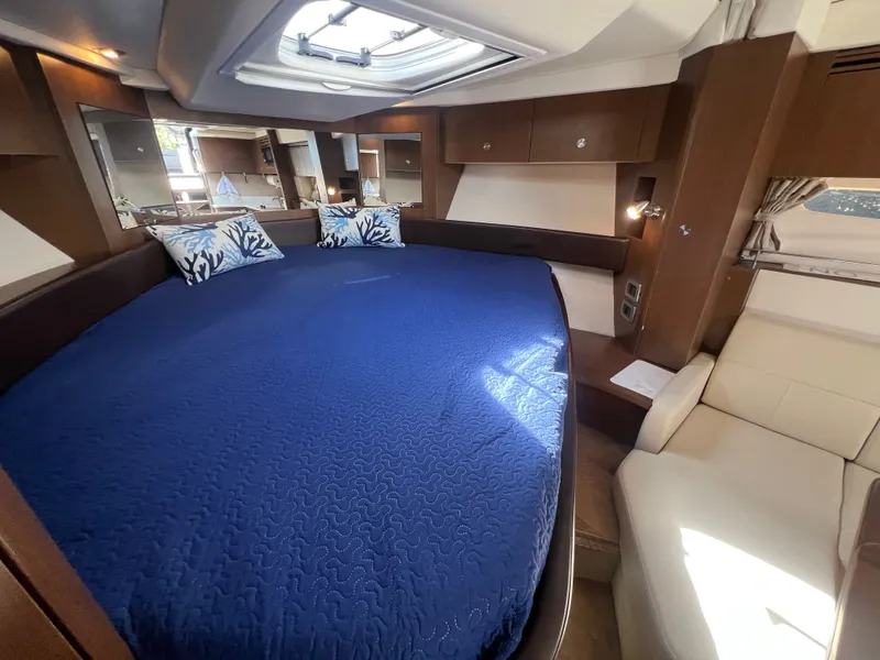 Slide: The Image of Interior of 2018 Sea Ray Sundancer 350 Coupe with blue bedding. - 30
