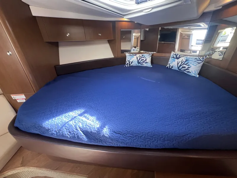 Slide: The Image of Interior of 2018 Sea Ray Sundancer 350 Coupe with blue bedding. - 31