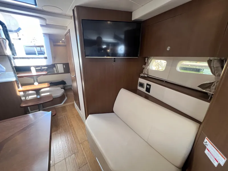 Slide: The Image of Interior of 2018 Sea Ray Sundancer 350 Coupe with sofa and TV. - 32