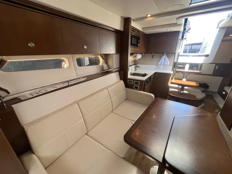 Slide: The Image of Interior of 2018 Sea Ray Sundancer 350 Coupe with kitchen and seating area. - 33